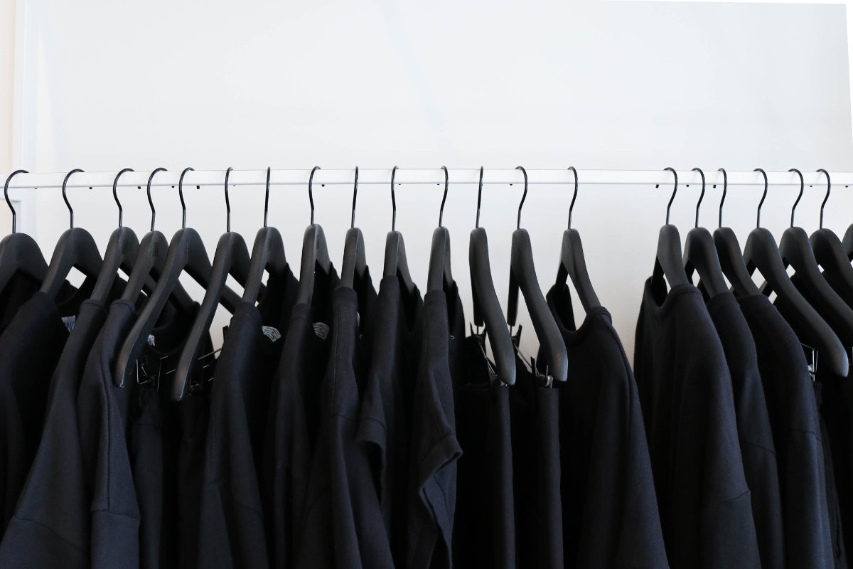 Clothes rack with black t-shirts hanging